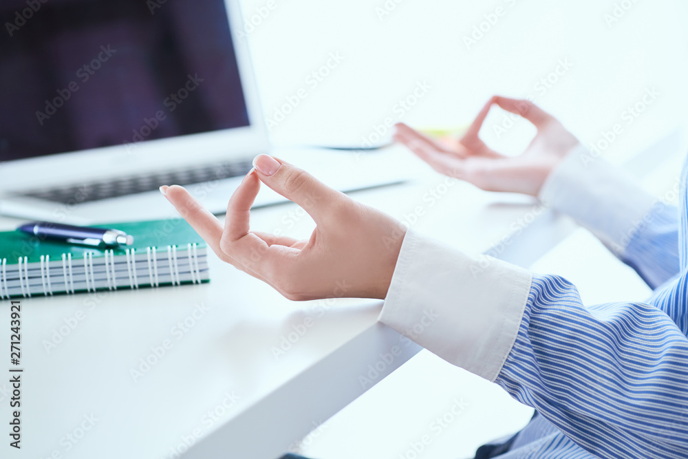 Calm businesswoman meditating at work, focus on female hands in mudra ... Calm businesswoman meditating at work, focus on female hands in mudra ...
